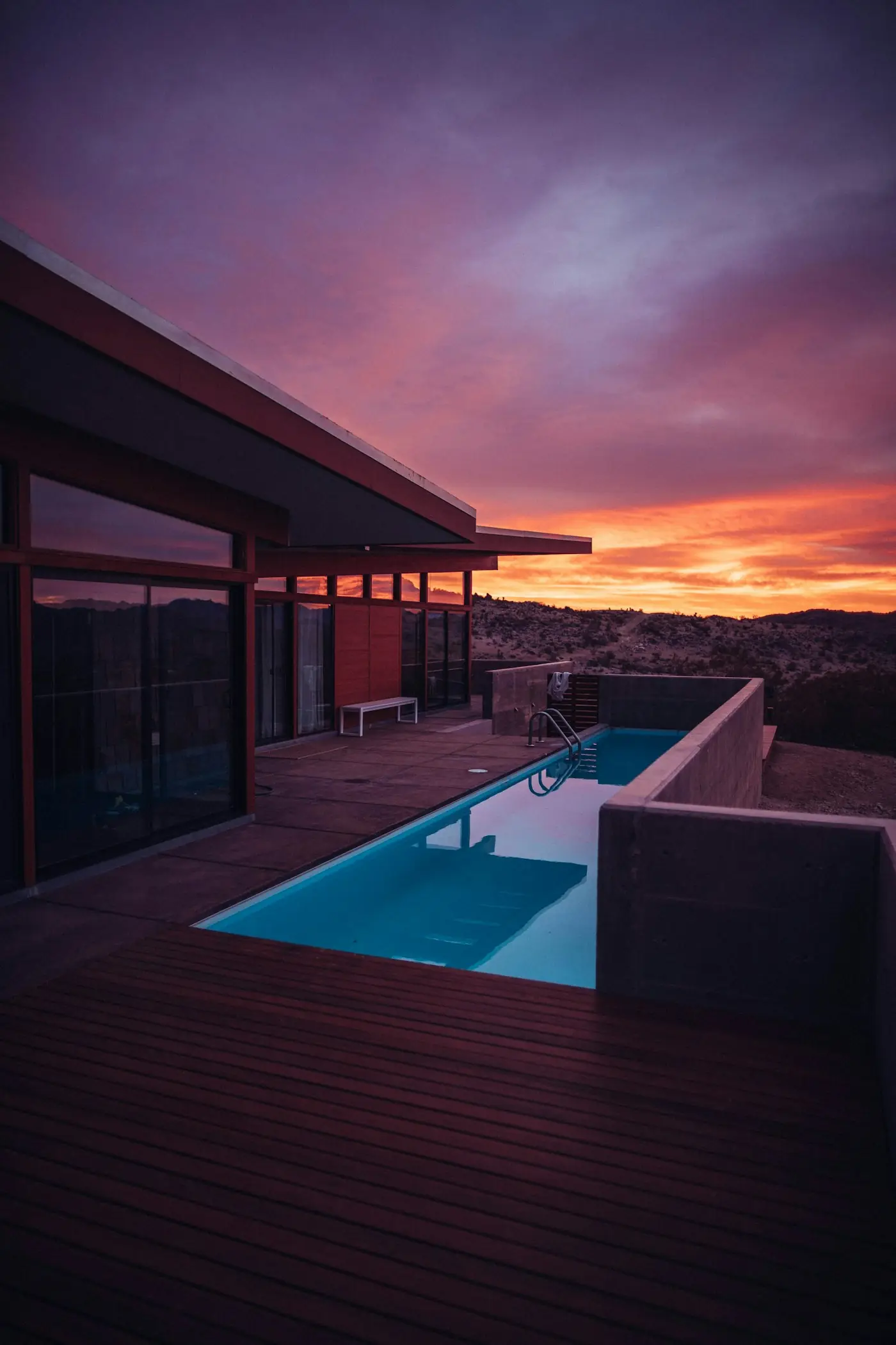 A villa terrace and pool at golden hour